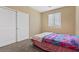 Bedroom featuring neutral walls, carpeted floors, and a closet, providing a functional and comfortable space at 6049 Paddleboat St, North Las Vegas, NV 89031