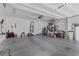Spacious garage with ample room for storage, featuring a light gray painted concrete floor and white walls at 6049 Paddleboat St, North Las Vegas, NV 89031