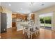 The kitchen features a wood table, tile backsplash, stainless appliances, and sliding glass door to yard at 6049 Paddleboat St, North Las Vegas, NV 89031