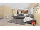 Cozy living room features a large gray sofa, neutral walls, and tile flooring at 6049 Paddleboat St, North Las Vegas, NV 89031