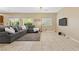 Spacious living room with tile flooring, view of TV, and natural light at 6049 Paddleboat St, North Las Vegas, NV 89031