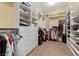 A large walk-in closet with an abundance of hanging space, shelves, and drawers at 6049 Paddleboat St, North Las Vegas, NV 89031