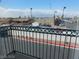 Balcony view showcases neighborhood landscape with palm trees lining the street at 6201 E Lake Mead Blvd # 218, Las Vegas, NV 89156