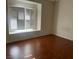 Bedroom with hardwood floors, plantation shutters, and light-filled space at 6201 E Lake Mead Blvd # 218, Las Vegas, NV 89156