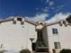 Exterior view of townhome with a red tiled roof and stairwell with green iron railings at 6201 E Lake Mead Blvd # 218, Las Vegas, NV 89156