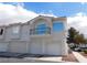 Exterior townhome with a three-car garage and balcony, showcasing classic architectural design at 6201 E Lake Mead Blvd # 218, Las Vegas, NV 89156