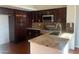 Kitchen with granite counters, stainless appliances and rich dark cabinets and hardwood floors at 6201 E Lake Mead Blvd # 218, Las Vegas, NV 89156