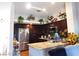 Well-lit kitchen featuring dark cabinetry and modern appliances at 6201 E Lake Mead Blvd # 218, Las Vegas, NV 89156