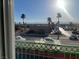 Daytime street view featuring palm trees and community buildings at 6201 E Lake Mead Blvd # 218, Las Vegas, NV 89156