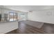 Bright living area with hardwood floors, a ceiling fan, a large window, and sliding glass doors at 6210 Blood Lily Ave, Las Vegas, NV 89122