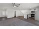 Open-concept living area with modern kitchen, hardwood floors, carpet, and plenty of natural light at 6210 Blood Lily Ave, Las Vegas, NV 89122