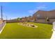 Large backyard with lush green lawn and desert landscaping, perfect for outdoor activities and relaxation at 6233 Blood Lily Ave, Las Vegas, NV 89122