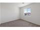 Cozy bedroom featuring neutral carpet and paint, with a bright window at 6233 Blood Lily Ave, Las Vegas, NV 89122