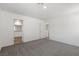 Minimalist bedroom with neutral carpet and paint, with doorways to closet and bathroom at 6233 Blood Lily Ave, Las Vegas, NV 89122