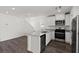Modern kitchen with stainless steel appliances, white cabinetry, and quartz countertops at 6233 Blood Lily Ave, Las Vegas, NV 89122