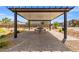 A covered patio area features a table, beautiful pavers, and landscaping in a well-maintained community at 6233 Blood Lily Ave, Las Vegas, NV 89122