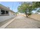 Wide backyard with a concrete patio area and gravel landscaping at 6244 Parsifal Pl, Las Vegas, NV 89107