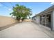 Backyard featuring a concrete patio and desert-friendly gravel landscaping at 6244 Parsifal Pl, Las Vegas, NV 89107