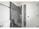 Modern bathroom with black marble-style tile shower and glass enclosure at 6244 Parsifal Pl, Las Vegas, NV 89107