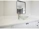 Bathroom vanity featuring a unique glass vessel sink, modern faucet, and bright countertops at 6244 Parsifal Pl, Las Vegas, NV 89107