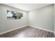 Bedroom features a large window letting in light and hardwood flooring at 6244 Parsifal Pl, Las Vegas, NV 89107
