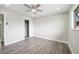 Well-lit bedroom featuring wood-look floors, a ceiling fan, and a closet at 6244 Parsifal Pl, Las Vegas, NV 89107
