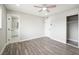 Spacious bedroom with wood-look flooring and ensuite bathroom at 6244 Parsifal Pl, Las Vegas, NV 89107