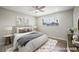 Cozy bedroom featuring a ceiling fan, neutral tones, and ample natural light at 6244 Parsifal Pl, Las Vegas, NV 89107
