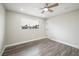 Bright bedroom features a modern ceiling fan, wood floors, neutral paint, and a window at 6244 Parsifal Pl, Las Vegas, NV 89107