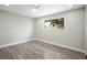 This bedroom is spacious and bright with hardwood floors and a large window at 6244 Parsifal Pl, Las Vegas, NV 89107