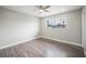 Bright bedroom with wood-look flooring and a ceiling fan at 6244 Parsifal Pl, Las Vegas, NV 89107