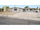 Inviting home exterior with spacious driveway and modern gray and white color scheme at 6244 Parsifal Pl, Las Vegas, NV 89107