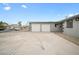 Front exterior featuring a two-car garage with a long driveway at 6244 Parsifal Pl, Las Vegas, NV 89107