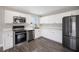This kitchen is equipped with stainless steel appliances, white cabinets, and modern countertops at 6244 Parsifal Pl, Las Vegas, NV 89107