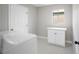 Bright laundry room with white washer, dryer and cabinets at 6244 Parsifal Pl, Las Vegas, NV 89107