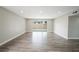 Spacious living room with neutral walls, recessed lighting, sliding glass door, and wood-look floors at 6244 Parsifal Pl, Las Vegas, NV 89107