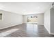 Bright, open living area with sliding glass door, recessed lighting, and sleek, modern flooring at 6244 Parsifal Pl, Las Vegas, NV 89107