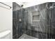 Modern bathroom shower featuring black marble tile and a rainfall shower head at 6244 Parsifal Pl, Las Vegas, NV 89107