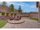 Outdoor oasis featuring a firepit seating area, manicured shrubs and artificial turf at 6985 Hopi Summit Ct, Las Vegas, NV 89149