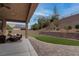 Backyard with covered patio, artificial turf putting green and built in outdoor seating at 6985 Hopi Summit Ct, Las Vegas, NV 89149