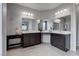 A large primary bathroom boasting dual sinks, dark cabinetry, and modern fixtures at 6985 Hopi Summit Ct, Las Vegas, NV 89149