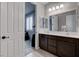 Bright bathroom features double sinks, dark cabinets, and modern tile floor at 6985 Hopi Summit Ct, Las Vegas, NV 89149