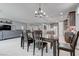 Bright dining area with modern lighting fixtures, flowing into an open-concept living space at 6985 Hopi Summit Ct, Las Vegas, NV 89149