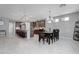Open kitchen and dining area with an island and modern lighting fixtures at 6985 Hopi Summit Ct, Las Vegas, NV 89149