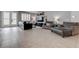 Spacious living room with neutral tile flooring, comfortable seating, and elegant finishes at 6985 Hopi Summit Ct, Las Vegas, NV 89149