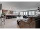 Open-concept living space features a kitchen with barstool seating and a comfortable sitting area at 6985 Hopi Summit Ct, Las Vegas, NV 89149