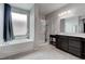 Modern main bathroom with double vanity, walk-in shower, and a soaking tub at 6985 Hopi Summit Ct, Las Vegas, NV 89149