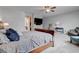 Bright main bedroom with plush carpeting, ceiling fan, and comfortable seating area at 6985 Hopi Summit Ct, Las Vegas, NV 89149