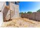 Backyard of home showing spiral staircase, block wall, and open area at 7553 Durham Hall Ave # 201, Las Vegas, NV 89130