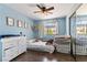 Bright bedroom featuring hardwood floors, neutral paint, a ceiling fan, and a large mirror closet at 7553 Durham Hall Ave # 201, Las Vegas, NV 89130